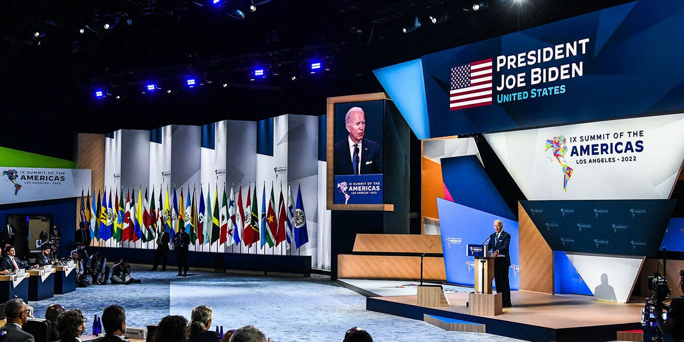 President Joe Biden on the stage. A large screen behind him read: President Joe Biden, United States, IX Summit of the Americas Los Angeles 2022